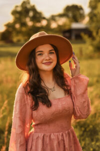 Iraland in a pink dress at sunset