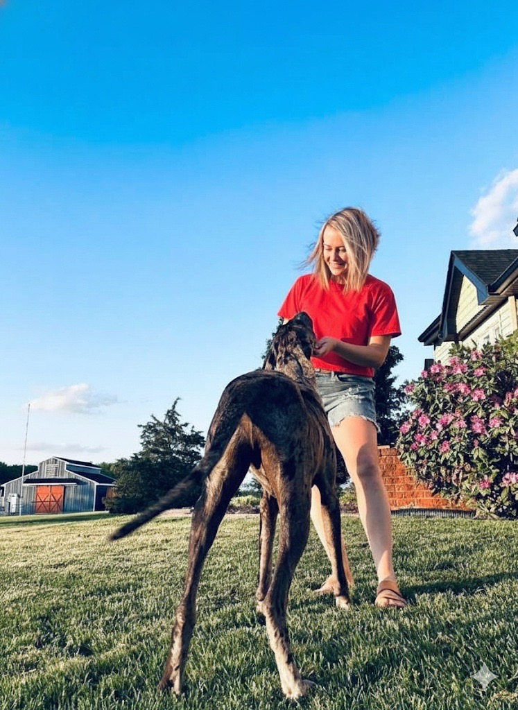 Brittany Bradley plays with her dog